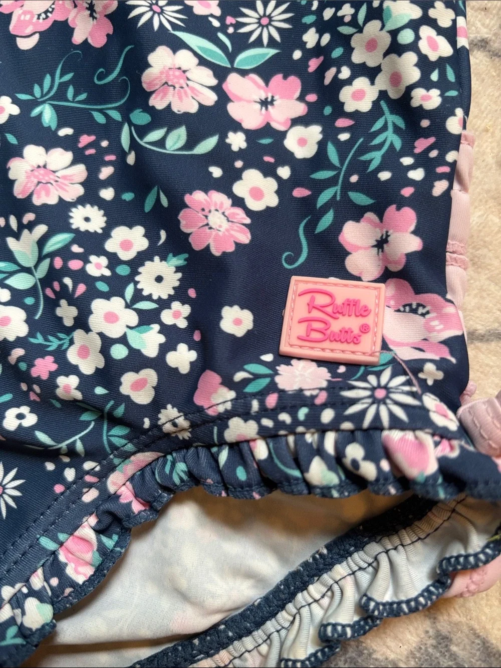 Ruffle Butts Navy Floral One-Piece Swimsuit with Pink Trim
